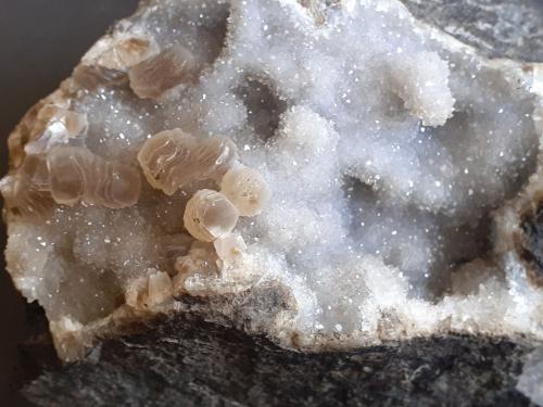 Close-up of stacked flat Calcite rhombohedrons on druzy Quartz. (Author: Volkmar Stingl)