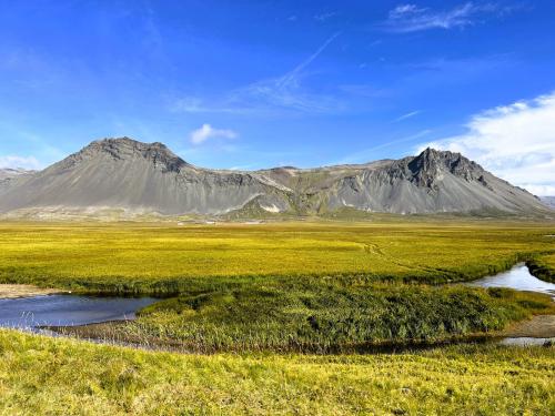 Las estribaciones de Búðahraun, en la península de Snæfellsnes, están protegidas por una cadena volcánica fuertemente erosionada cuyo material detrítico se acumula es las laderas y ha formado la llanura sobre la que se construyó Búðakirkja. (Autor: Antonio P. López)