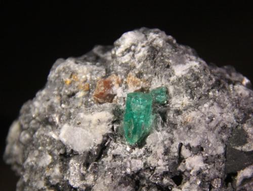 Beryl (variety emerald), Parisite and Calcite<br />Muzo (distrito minero), Cinturón Esmeraldífero Occidental, Departamento Boyacá, Colombia<br />45mm x 42mm x 36mm<br /> (Author: Firmo Espinar)