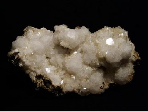 Analcime + stilbite + thomsonite, laumontite + chabazite
Moonen Bay, Isle of Skye, Scotland, UK
Specimen 16 cm x 8 cm x 8 cm
Crystals to 20 mm

Analcime crystals to 20mm on matrix with stilbite, thomsonite, laumontite and chabazite. Specimen 16cm x 8cm x 8cm; self-collected 2003 from Moonen Bay, Isle of Skye, Scotland. (Author: Mike Wood)