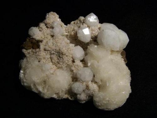 Analcime + chabazite + stilbite
Moonen Bay, Isle of Skye, Scotland, UK
Crystals to 13 mm

Analcime crystals to 13mm on matrix with pink chabazite and stilbite. Self-collected 1997 from Moonen Bay, Isle of Skye, Scotland. (Author: Mike Wood)