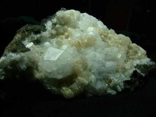 Analcime + stilbite + thomsonite + calcite
Oisgill Bay, Isle of Skye, Scotland, UK
Specimen 14 cm x 9 cm.
Large analcime crystal is 24 mm wide

Analcime + stilbite + thomsonite + orange calcite. The large analcime crystal is 24mm wide. The specimen is 14cm x 9cm. Self-collected 1996 from Oisgill Bay, Isle of Skye. (Author: Mike Wood)