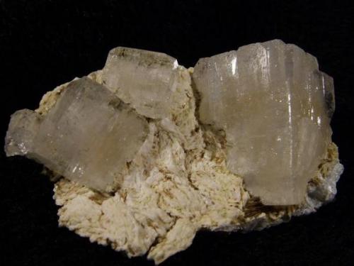 Apophyllite + ’gyrolite’. Large chunky apophyllite crystals with corner modifications, nice and lustrous. The big crystal measures 23mm x 19mm x 17mm. The gyrolite looks somewhat altered - it might be something else now. Specimen measures 53mm wide x 30mm x 25mm. Self-collected 2009 from near to Ollisdal Geo, Duirinish, Isle of Skye. (Another remote locality in this area of Skye). (Author: Mike Wood)