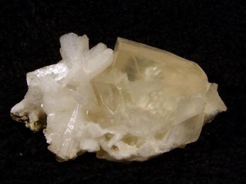 Calcite + stilbite. Nice yellowish rhombohedral calcite crystal to 15mm on the front edge, associated with small white stilbite crystals. Specimen is 37mm wide x 20mm high x 20mm deep. Self-collected 1992 from Sgurr an Duine, Minginish, Isle of Skye. ( Sgurr an Duine is the cliff/beach immediately north of Sgurr nam Boc.) (Author: Mike Wood)