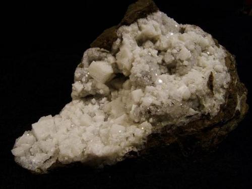 Chabazite + analcime. A large specimen with white chabazite crystals to 10mm resting on small transparent analcime crystals. Specimen measures 14cm wide x 8cm high x 7cm deep. Self-collected 1997 from Sgurr nam Fiadh, Minginish, Isle of Skye, Scotland. (Another remote locality, 5km south of Talisker Bay). (Author: Mike Wood)