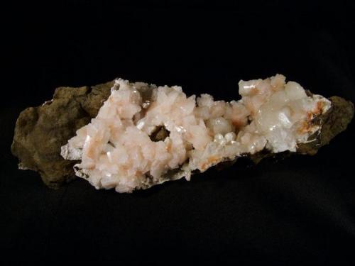 Heulandite
Sgurr nam Boc, Isle of Skye, Scotland, UK
Specimen measures 17 x 6 x 5 cm
Pink Heulandite crystals to 10 mm

Pink Heulandite crystals to 10mm with some white ’cauliflower’ stilbites. Specimen measures 17 x 6 x 5cm. Self-collected in 1992 from Sgurr nam Boc, Isle of Skye. (Author: Mike Wood)