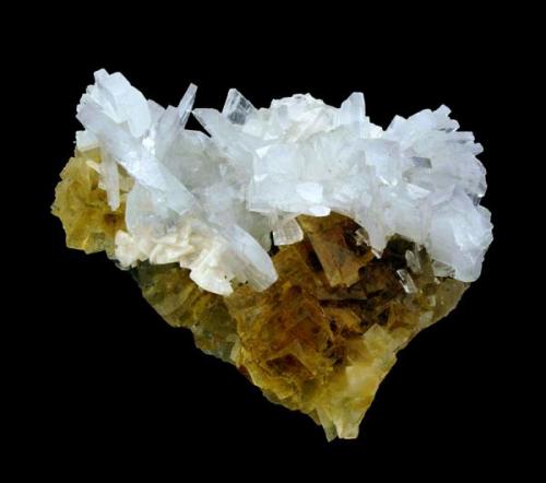 Group of tabular crystals of bluish Barite on a base of cubic crystals of Fluorite deeply colored in honey yellow.
Moscona Mine (Author: Joan Rosell)