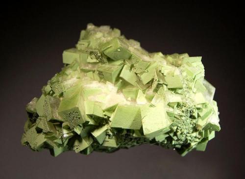 Calcite
Tsumeb Mine, Tsumeb, Namibia
5.7 x 8.1 cm.
Intergrown rhombs of colorless calcite to 1.5 cm on edge dusted with sparkly light green duftite. (Author: crosstimber)