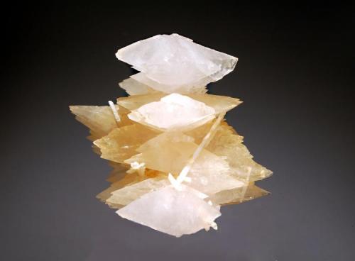 Calcite
Verchniy Mine, Dal’negorsk, Primorskiy Kray, Russia
4.1 x 4.6 cm.
Two generations of scalenohedral calcites ranging in color from honey-colored to colorless, with rod-shaped crystals of milky-white aragonite. (Author: crosstimber)