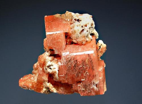 Serandite
Poudrette Quarry, Mont Saint-Hilaire, Monteregie, Quebec, Canada
3.8 x 4.0 cm.
Blocky salmon-colored serandite crystals with minor white albite and reddish-brown microcrystals of manganoneptunite. (Author: crosstimber)