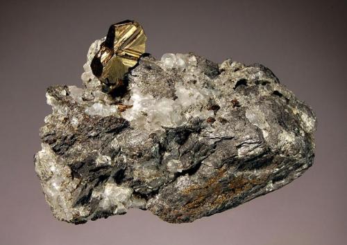 Cubanite
Henderson Mine # 2, Chibougamou, Quebec, Canada
3.7 x 6.9 cm.
Sharply twinned lustrous cubanite crystal on matrix. This mine produced the finest cubanite crystals known, and closed in 1988. (Author: crosstimber)