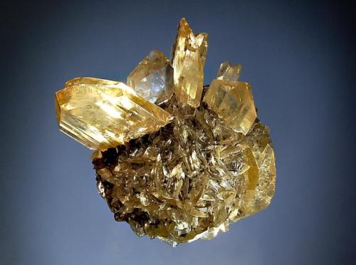 Gypsum
Red River Floodway, Winnipeg, Manitoba, Canada
7.5 x 9.1 cm.
Bladed gypsum crystals forming a sphere 7.0 cm in diameter with several twinned yellow crystals protruding from the sphere. (Author: crosstimber)