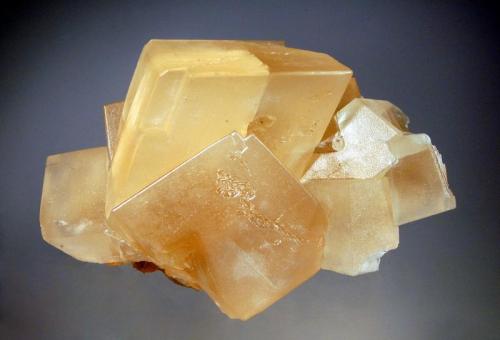 Calcite
Pine Point Mine, Northwest Territories, Canada
7.0 x 10.0 cm.
Honey-colored calcite rhombs to 4.5 cm on edge with frosted crystals faces. (Author: crosstimber)