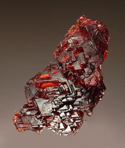 Spessartine
Navegadora Mine, Penha do Norte, Minas Gerais, Brazil
2.5 x 4.5 cm.
Gemmy burgundy-red crystal exhibiting striations and stepped growth features. (Author: crosstimber)
