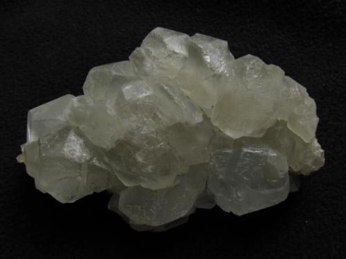 Calcite
Sgurr nan Cearcall, nr Glen Brittle, Isle of Skye, Scotland, UK
63mm x 40mm x 20mm deep
Calcite crystals in ’nailhead’ habit, found on the sides of a large, otherwise empty cavity in a huge boulder. The only calcite I recall seeing at this locality. The glossy sheen is natural (etching from sea-water?).
Self-collected 2011 (Author: Mike Wood)