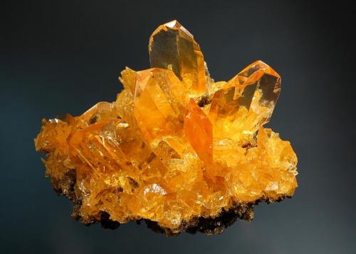 Gypsum
Salinas de Otuma, Paracas, Pisco, Pisco Province, Ica Department, Peru
7.5 x 8.6 cm.
Transparent, orange twinned crystals to 2.5 cm scattered on a friable matrix of smaller gypsum crystals and halite. Mined in summer 2002. (Author: crosstimber)