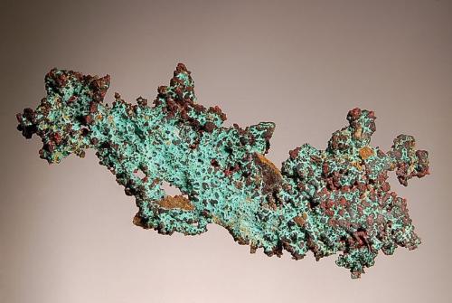 Copper
Oumjrane Mine, Alnif, Tarhbalt, Er Rachidia Province, Morocco
3.5 x 8.0 cm.
An elongated plate of native copper with small octahedral crystals and a light coating of green malachite. (Author: crosstimber)