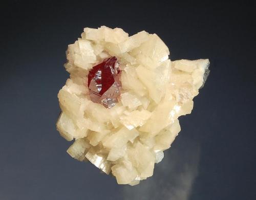 Cinnabar
Tongren Mine, Wanshan Dist.Tongren Pref., Guizhou Prov., China
3.5 x 4.5 cm
Sharp, cherry-red, twinned cinnabar crystal on rhombic white dolomite crystals. (Author: crosstimber)