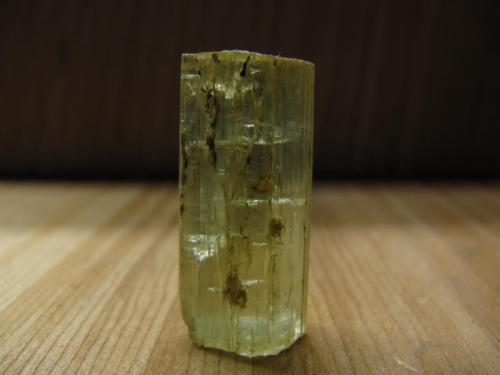 Beryl
Ben a’ Bhuird, Cairngorm Mountains, Grampian Region, Scotland, UK
20mm x 8mm x7mm
Transparent pale green beryl crystal, heavily striated along it’s length with a slightly etched termination. From a small pocket in a thin pegmatite vein in granite. (Author: Mike Wood)