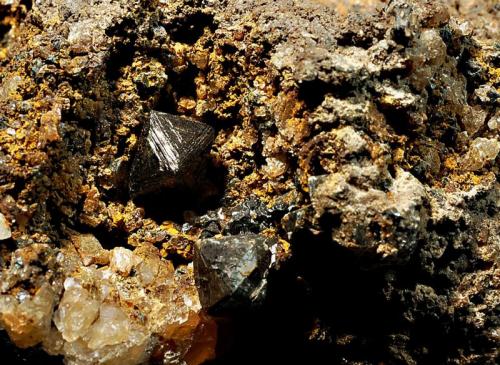 Gahnite
Mt. Peak Mine, Charlemont, Franklin Co., Massachusetts
5.5 x 6.1 cm
Black octahedral crystals to 5 mm on edge embedded in an iron-rich matrix. (Author: crosstimber)