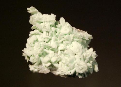 Hemimorphite
Skorpion Mine, Rosh Pinah, Karas Region, Namibia
3.8 x 5.9 cm
Finely crystallized sheaves and fanlike forms of pale green hemimorphite pseudomorphing tarbuttite and overcoating a thin gray-blue layer of apatite. (Author: crosstimber)