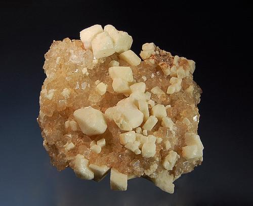 Leonite ps. after picromerite
Wintershall Potash Works, Heringen, Hesse, Germany
8.0 x 8.0 cm
Opaque white leonite crystals on a pinkish halite matrix.  The leonite crystals are pseudomorphs of picromerite, which is colorless when fresh, but quickly alters white leonite by dehydration. (Author: crosstimber)