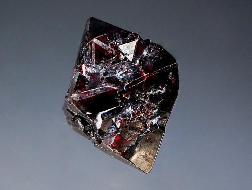 Cuprite
Poteryaevskoe Mine, Rubtsovskoe Cu-Zn-Pb deposit, Rudnyi Altai, Western-Siberian Region, Russia
2.0 x 2.5 cm
Single lustrous octahedral cuprite crystal with dark reddish highlights. (Author: crosstimber)