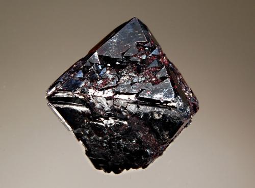 Cuprite
Poteryaevskoe Mine, Rubtsovskoe Cu-Zn-Pb deposit, Rudnyi Altai, Western-Siberian Region, Russia
3.0 x 3.7 cm
A deep red complex octahedral cuprite crystal. (Author: crosstimber)