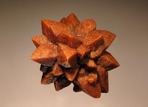 Calcite ps. ikaite
Olenitsa River, White Sea Coast, Kola Peninsula, Murmanskaja Oblast, Russia
3.7 x 4.0 cm
Typical stellate pseudomorph of orange-brown calcite after ikaite,         sometimes known as ‘glendonite.’ (Author: crosstimber)