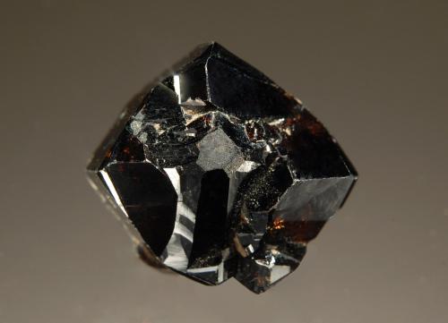 Cassiterite
Inverell, Hardinge Co., New South Wales, Australia
1.6 x 1.8 cm
A lustrous dark brown cassiterite crystal with root beer-colored internal highlights. (Author: crosstimber)