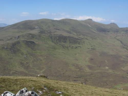 Ben Loyal, Sutherland, Scotland
The next day it was really sunny and I drove round to the east side of the mountain, which looks like this. The slopes are much more gentle but there is hardly any bare rock. The photo was taken from the top of Cnoc nan Cuilean (557m) which apparently is a distinctly different part of the syenite intrusion, containing more mafic minerals and elevated REE’s. I didn’t see anything worth jumping up and down about. Oh except perhaps an otter in the burn (stream) that I followed to get there. (Author: Mike Wood)