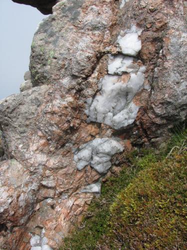 Ben Loyal, Sutherland, Scotland
I came across this section of pegmatite vein, which wasn’t exotic, merely containing pink microcline and quartz, and not showing any euhedral crystals. But it showed I was getting warmer.. (Author: Mike Wood)