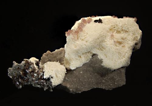 Celestine
Cumberland Mine, Carthage, Smith County, Tennessee, USA
5.0 x 8.5 cm
One of the less frequently seen minerals from Elmwood - creamy white acicular celestine with dark brown sphalerite and pale purple fluorite cubes. (Author: crosstimber)