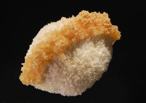 Calcite
Kannad, Aurangabad District, Maharashtra, India
5.2 x 6.8 cm
A hemisphere of white scolecite with a narrow band of amber-colored calcite running from one side to the other and a few pale tan stilbite crystals (Author: crosstimber)