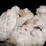 Quartz (variety milky quartz) on CalciteAfloramientos Carretera Estatal 37, Harrodsburg, Clear Creek, Condado Monroe, Indiana, USAthe specimen max dimension is 12 cm   the calcite is 5 cm (Author: Bob Harman)