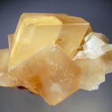 Calcite
Pine Point Mine, Northwest Territories, Canada
7.0 x 10.0 cm.
Honey-colored calcite rhombs to 4.5 cm on edge with frosted crystals faces. (Author: crosstimber)