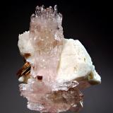 Quartz var. rose quartz
Alto da Pittora, Laranjeiras, Galiléa , Minas Gerais, Brazil
6.0 x 6.8 cm.
Gemmy pink crystals set upon a matrix of blocky white orthoclase crystals with muscovite. (Author: crosstimber)