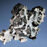 Bournonite
Pachapaqui District, Bolognesi Prov., Ancash Dept. Peru
5.2 x 6.8 cm
Classic cogwheel-shaped crystals of metallic black bournonite partially overgrown with colorless quartz crystals. (Author: crosstimber)