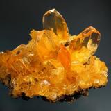 Gypsum
Salinas de Otuma, Paracas, Pisco, Pisco Province, Ica Department, Peru
7.5 x 8.6 cm.
Transparent, orange twinned crystals to 2.5 cm scattered on a friable matrix of smaller gypsum crystals and halite. Mined in summer 2002. (Author: crosstimber)