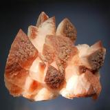 Calcite
Leiping Mine, Guiyang Co., Chenzhou Pref,, Hunan Prov., China
11.0 x 15.0 cm.
Milky white Calcite crystals terminated by a steep pyramid and tinged reddish brown with iron oxides. (Author: crosstimber)