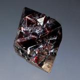 Cuprite
Poteryaevskoe Mine, Rubtsovskoe Cu-Zn-Pb deposit, Rudnyi Altai, Western-Siberian Region, Russia
2.0 x 2.5 cm
Single lustrous octahedral cuprite crystal with dark reddish highlights. (Author: crosstimber)